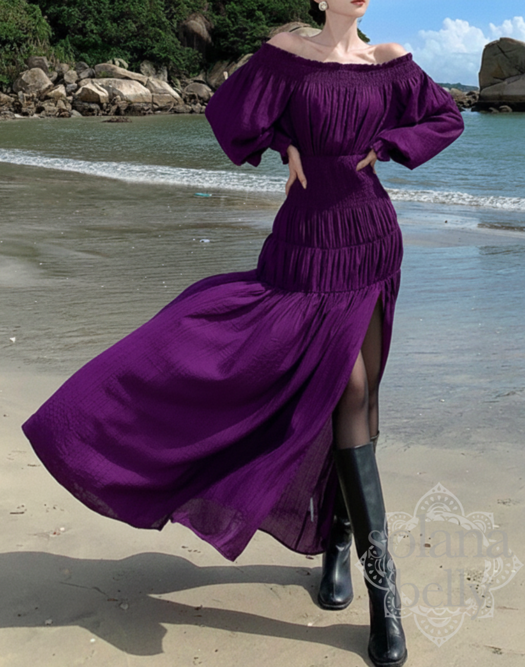 砂浜で紫のガラベーヤワンピースを着たモデルが正面に立ち、風でスカートが大きく広がる様子。ベリーダンスの衣装やレッスン着の上から羽織れる軽い生地感と動きの美しさが分かる構図。